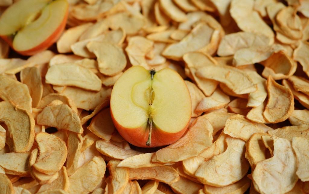 Dried apple slices with a fresh halved apple